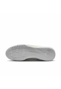 Shoe sole with a textured rubber surface, featuring a white color and a patterned tread for traction. Includes a logo embossed on it.