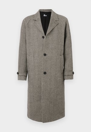 Juodai baltas šukuotos gamybos paltas su žuvų kaulų raštu, įrengtas su apykakle, penkiomis sagomis ir užsuktais rankovėmis. Pagamintas iš tekstūruotos medžiagos.