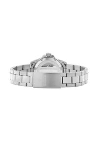 Orologio in acciaio inossidabile con finitura lucida, bracciale a maglia, cassa rotonda e chiusura a morsetto. Il fondello trasparente mostra il meccanismo interno.