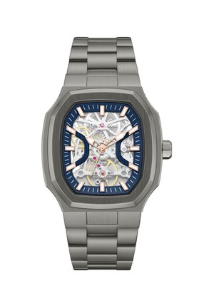 Firkantet armbåndsur i rustfrit stål med synlige tandhjul, markører i rosaguldfarve og blå accenter på urskiven.