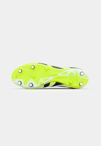 Soccer cleat with a bright yellow outsole and black upper, featuring a textured pattern and six metallic studs for traction.