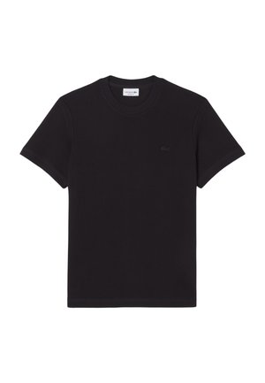 Zwart katoenen T-shirt met korte mouwen, een ronde hals en een klein geborduurd krokodillenlogo op de linkerbovenkant.