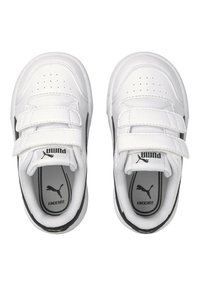 Baskets blanches avec des accents noirs, fabriquées en matériau synthétique. Elles disposent de deux bandes Velcro, d'un empiècement perforé au niveau des orteils et du logo "PUMA" à l'intérieur.
