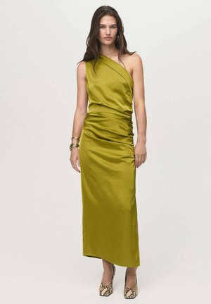 One-shoulder olive green satin dress with gathered detail, side slit, and a sleek, floor-length silhouette. Paired with animal print heels.