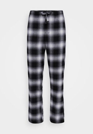Czarno-białe spodnie w kratę z elastycznym pasem i sznurkiem do regulacji. Materiał ma miękką teksturę i luźny krój.