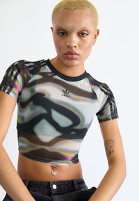 Short-sleeve, cropped top made of mesh fabric with a colorful abstract pattern. Features black trim and an Adidas logo on the chest.