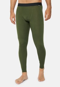 Olivgröna termolegins med en figurnära design, texturerad väv och ett svart elastiskt midjeband. Inga synliga mönster eller hårdvara.