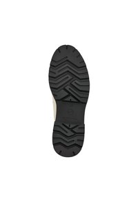 Zwarte rubberen schoenzool met zigzagprofiel, voorzien van een circulair logo en maat 37 aanduiding. Glad beige bovenwerk zichtbaar aan de randen.