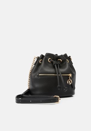 Black bucket bag made of textured leather featuring gold hardware, drawstring closure, and a front zipper pocket with a charm accent.