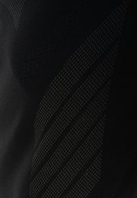 Zwart textiel met een gestructureerd patroon van diagonale strepen en chevrons die subtiel contrast en diepte creëren.