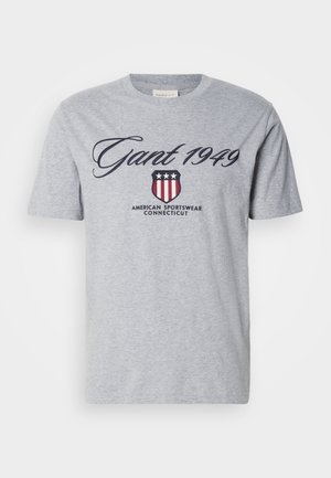 Gray cotton t-shirt with short sleeves, featuring "Gant 1949" in cursive script and a shield logo with stars and stripes.