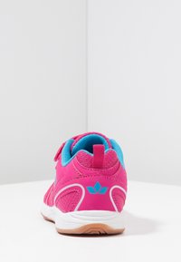 Pink athletic shoe with blue accents, mesh upper, and a rubber sole. Features a padded collar and a hook-and-loop closure system.
