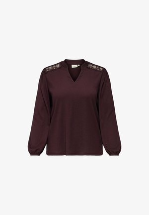 Burgunderfärgad långärmad topp med V-ringning, spetsdetaljer på axlarna och åtsittande ärmslut. Mjukt tyg med avslappnad passform och texturerad yta.