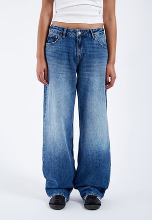 Wide-leg, light blue denim jeans with a faded texture, five-pocket design, and metal buttons. Features frayed hem and dark interior seam stitching.