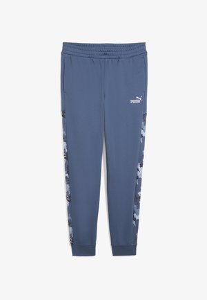 Pantalon de jogging bleu en tissu doux, avec un motif abstrait noir et bleu sur les côtés et une taille élastique avec un détail de logo.