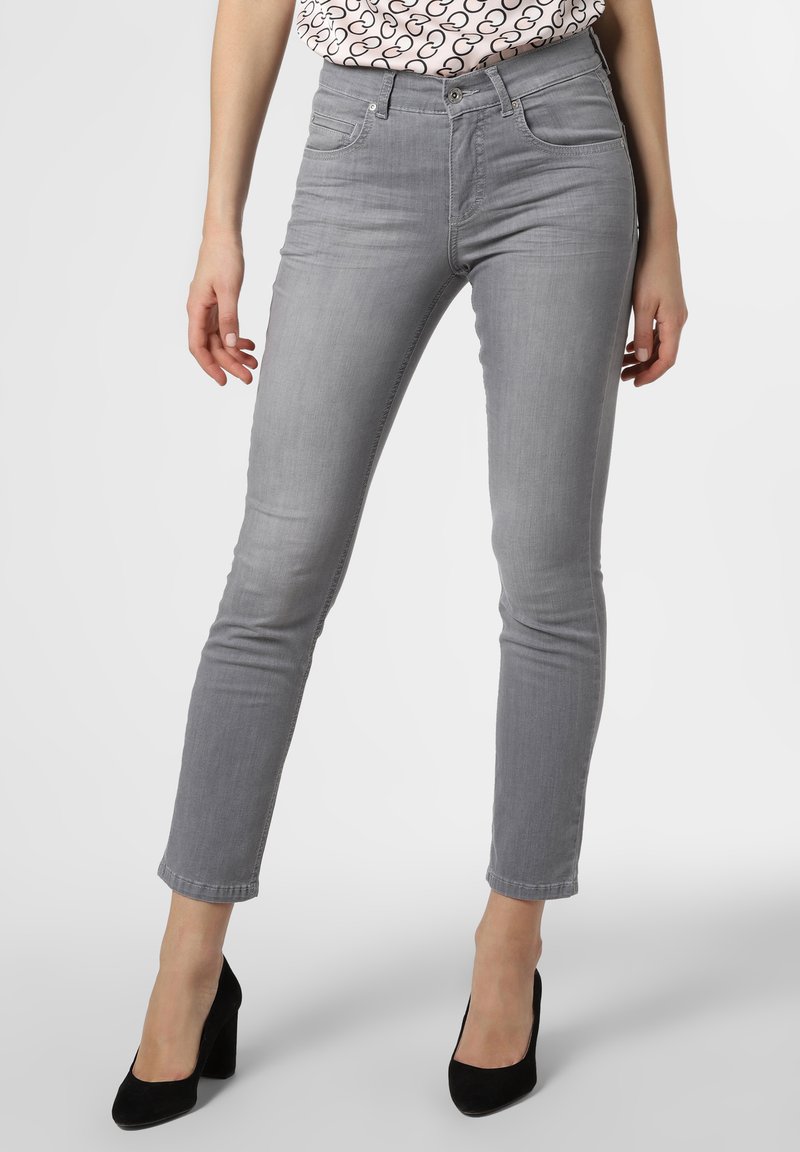 Grey skinny jeans made of denim, featuring a mid-rise waist, classic five-pocket design, and stitched detailing. Paired with black high heels.
