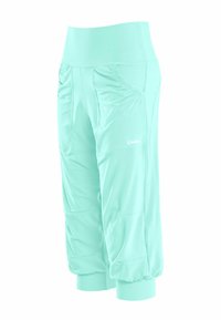 Capri atletici color acquamarina realizzati in tessuto elastico, con tasche laterali, dettagli arricciati e polsini elasticizzati per una vestibilità aderente.