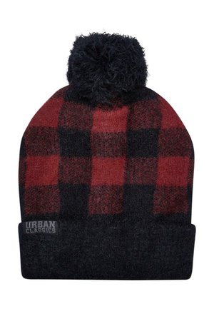 Knitted beanie hat in red and black checkered pattern with a fluffy black pom-pom on top and a black folded cuff featuring a logo.