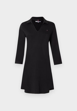 Black dress featuring a v-neck and a collar, made from a smooth fabric with three-quarter sleeves, and a small logo detail on the chest.