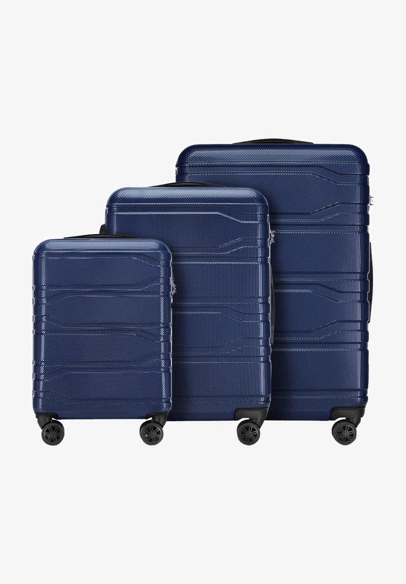 Ensemble de valises rigides bleu marine avec surface texturée, comprenant trois tailles empilées. Chaque valise dispose d'une poignée rétractable et de quatre roues.