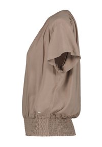 Beige lyhythihainen paita, jossa on rento malli, smokkikääntöalaosa ja sileä, kevyt kangas.