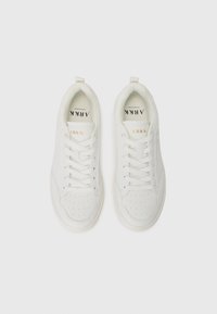 White sneakers with a smooth leather upper, lace-up design, perforated detailing near the toe, and gold "ARKK" branding on the tongue.