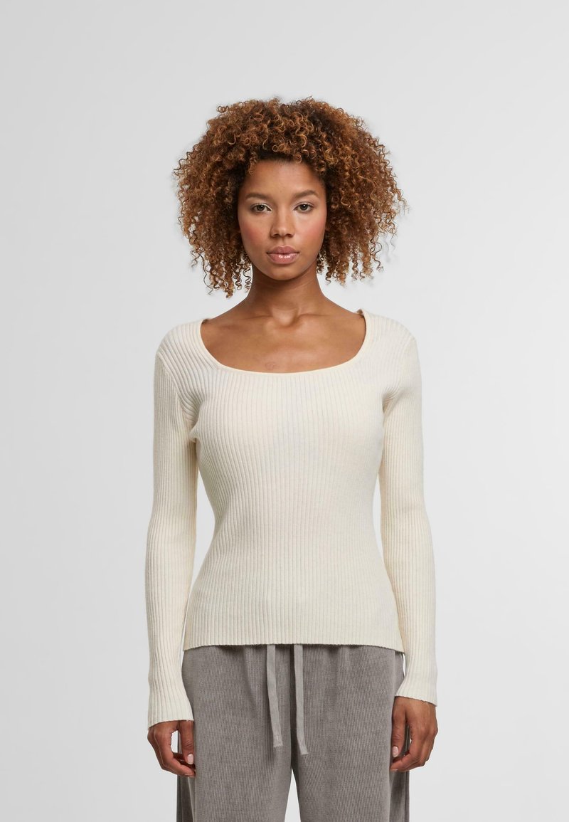 Cremfarbener, gerippter Langarmpullover mit einem quadratischen Ausschnitt. Weicher Stoff, taillierte Passform und sanfter Stretch ergänzen einen lässigen Stil.