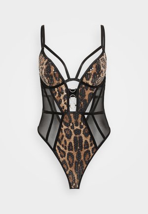 Leopard print bodysuit featuring sheer black panels, adjustable straps, and metal circle accents on the front. Textured fabric with sequins.