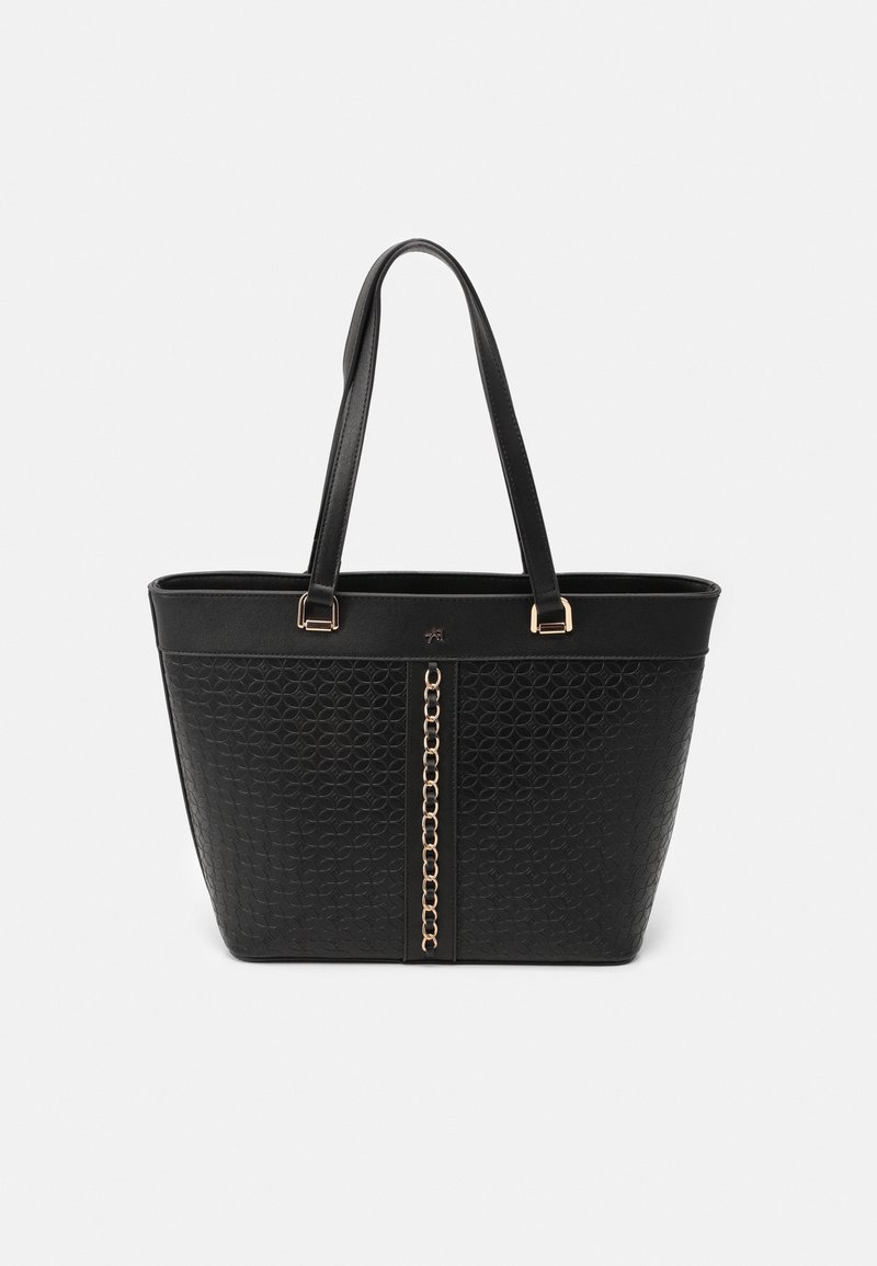 Sac fourre-tout noir avec motif circulaire texturé, deux bretelles et un détail de chaîne dorée verticale au centre devant.