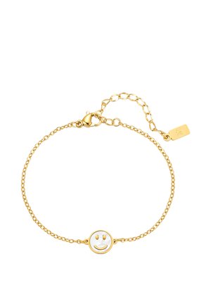 Hübsches Armband aus einer zarten Goldkette mit einem zentralen weißen Smiley-Anhänger und einem verstellbaren Verschluss mit einem kleinen goldenen Anhänger.