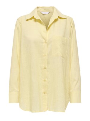 Chemise à manches longues jaune clair, boutonnée, avec col et poche poitrine, fabriquée dans un tissu légèrement texturé.