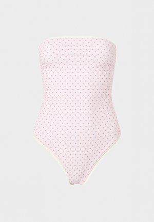 Μαγιό σε απαλό ροζ χρώμα χωρίς τιράντες με μικρές καφέ πουά και ψηλές ανοίγματα στα πόδια, παρουσιάζεται σε απλό λευκό φόντο.