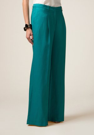 Teal wide-leg trousers made from a smooth fabric, featuring a front pleat, belt loops, and a clean, tailored waistband.