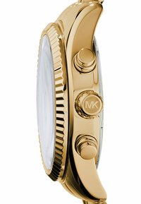 Orologio color oro con cassa tonda, bezel testurizzato e tre pulsanti. Il vetro anteriore è trasparente, rivelando un quadrante bianco.