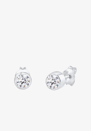 Silberne Steckerohrringe mit einem runden, klaren Zirkonia-Stein, der in einer polierten Metallbasis eingesetzt ist, mit einer sicheren Befestigung.