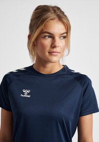 Navy blue sports t-shirt made of lightweight fabric, featuring a crew neckline, short sleeves, and contrasting white logo and accents.