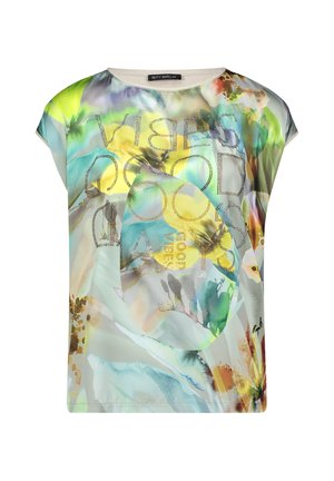 Blouse à motif floral multicolore en tissu transparent, manches courtes, avec texte en strass "GOOD VIBES" sur le devant.