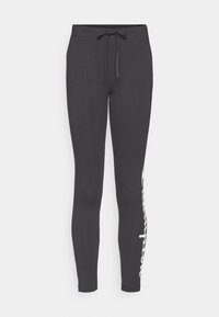 Pantaloni della tuta neri con vita regolabile e dettaglio del logo bianco sul lato sinistro. Realizzati in tessuto morbido, design affusolato con polsini aderenti.