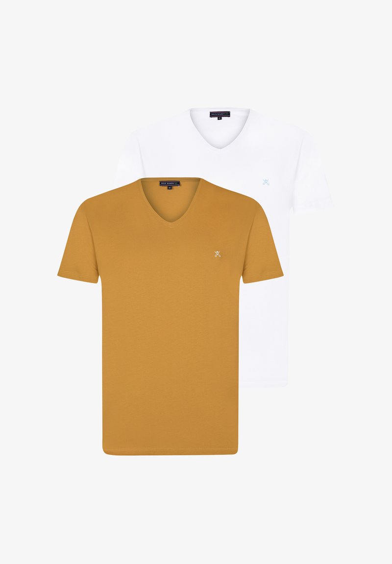V-kaelusega T-särkide komplekt, mis sisaldab ühte sinepikollast ja ühte valget särk. Pehme kangas, millel on igas särgis lähedal kaelaribale minimalistlik logo.