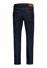 Σκούρο μπλε τζιν με ίσια γραμμή, με ταμπέλα από καφέ δέρμα στο πίσω μέρος, δύο πίσω τσέπες και κεντήματα σε κίτρινο χρώμα.