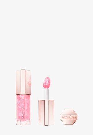 Rosafarbener Lipgloss in einer transparenten Tube mit sechseckigem Deckel. Weicher Applikatorstab ist sichtbar und zeigt eine schimmernde Textur.