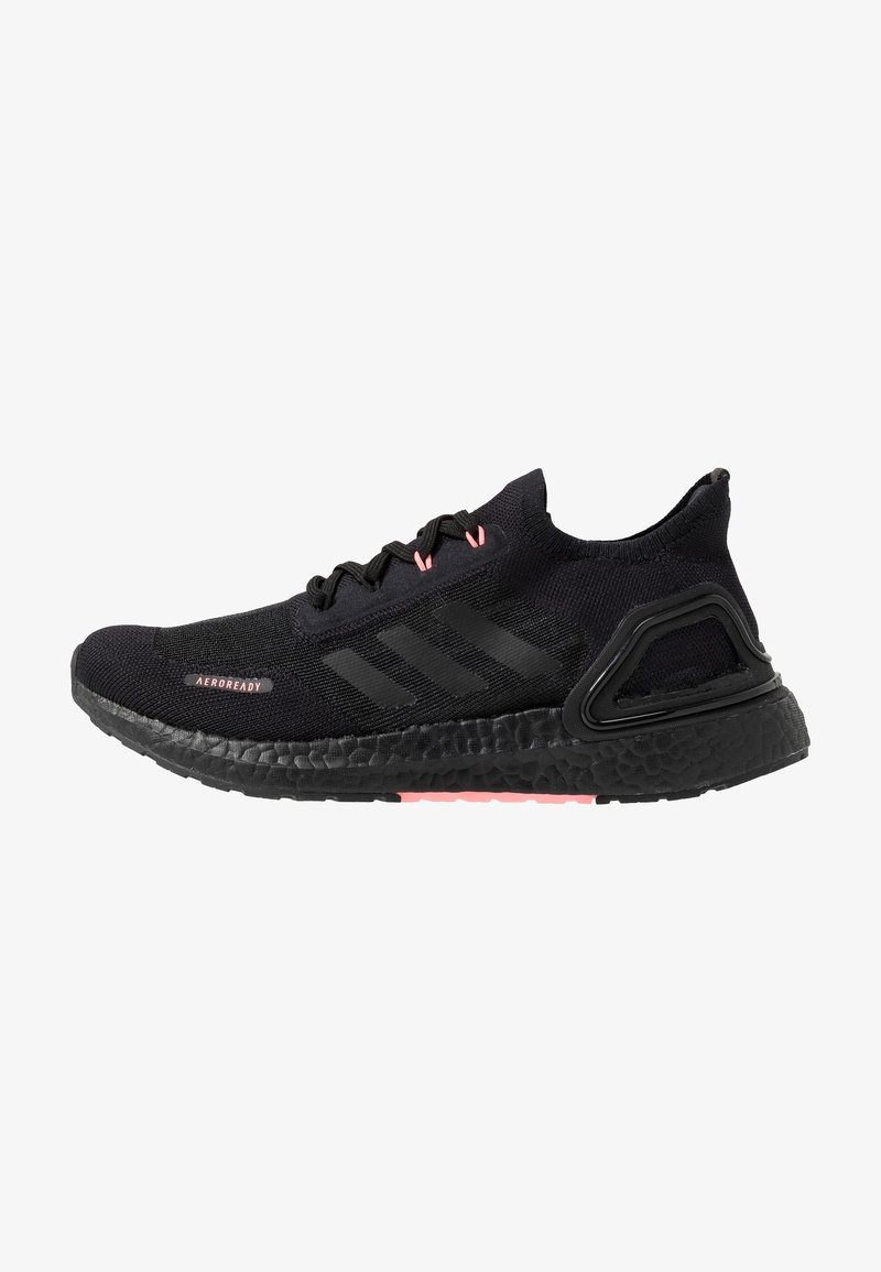 Black athletic shoe with pink accents and textured sole, featuring a woven upper and three black stripes on the side.