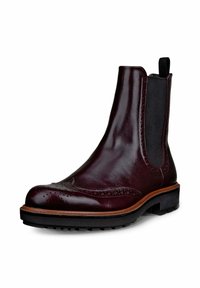 Bottes Chelsea en cuir bordeaux avec des détails de brogue, des panneaux élastiques sur les côtés et une semelle en caoutchouc noire ; design élégant avec une finition lisse.