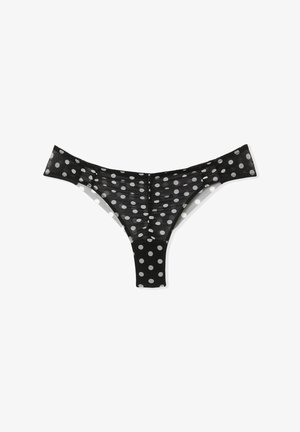 Tanga nero con pois realizzato in tessuto trasparente, caratterizzato da pois bianchi, una cintura sottile e un design a V sul retro.