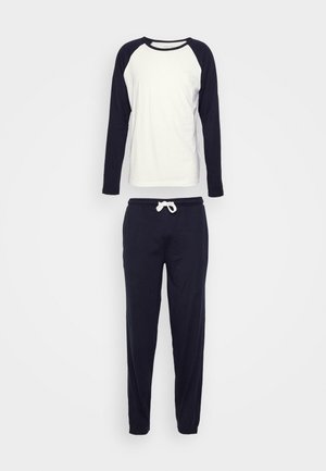 Langärmliges Oberteil in Weiß und Marineblau mit Raglanärmeln, kombiniert mit einer Hose mit elastischem Taillenbund in Marineblau und Zugband. Weicher Baumwollmix, lässige Passform.