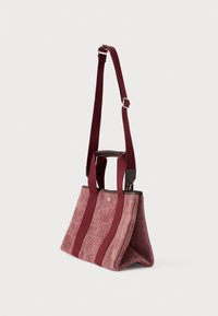 Μπορντό υφασμάτινη τσάντα ώμου με δύο κοντά χερούλια και αποσπώμενο μακρύ λουρί, με αντίθετες μπορντό ρίγες και μεταλλικές λεπτομέρειες.