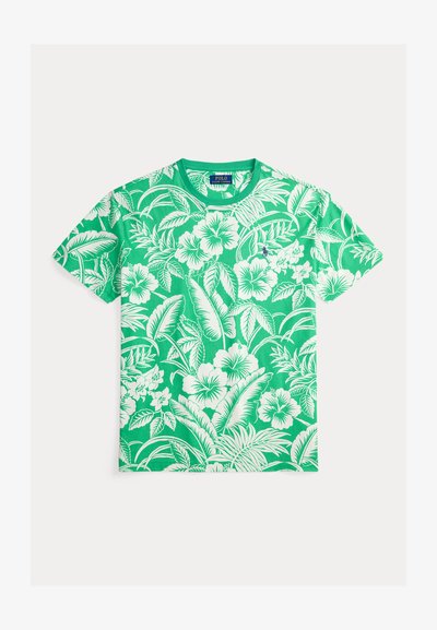 Πράσινο βαμβακερό t-shirt με λευκό ανθισμένο μοτίβο ιβίσκου. Στρογγυλή λαιμόκοψη και κοντά μανίκια. Μαλακή υφή με ζωντανά χρώματα.