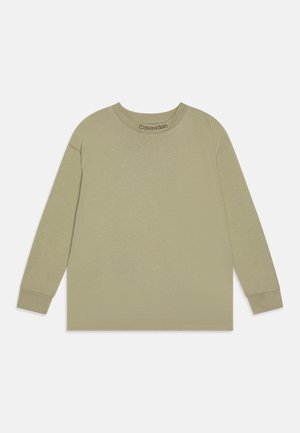 T-shirt beige à manches longues avec col rond, poignets côtelés et logo Calvin Klein imprimé à l'intérieur du col.