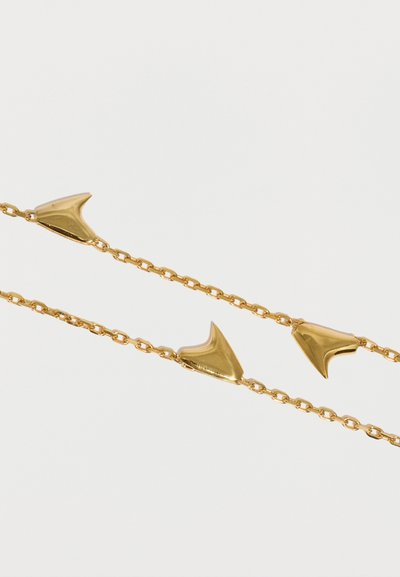 Divas smalkas zelta ķēdītes ar pulētu, abstraktu trīsstūrveida formu saitēm uz vienmērīgas baltas fona.