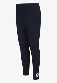 Marine leggings med elastisk midje, glatt tekstur og en logo patch nær anklene. Fitted form, egnet for aktivt bruk.